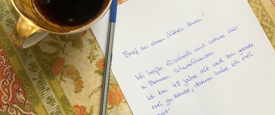 Ein handgeschriebener Brief liegt neben einer Kaffeetasse.